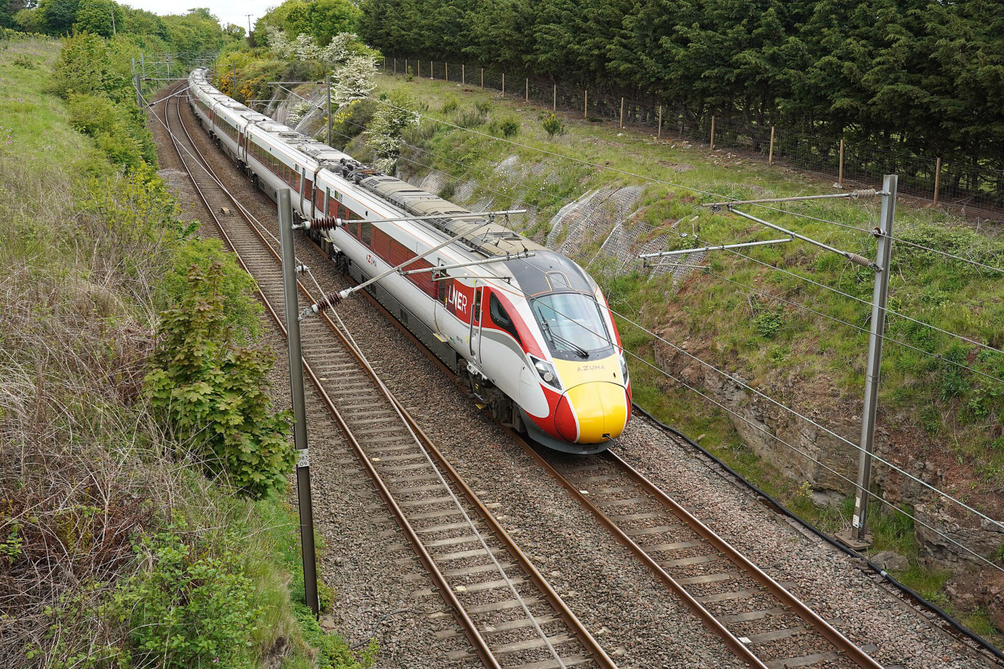 An LNER Azuma express train in the British countryside